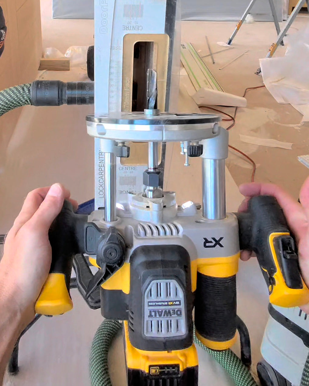 A DeWalt XR cordless plunge router with a 160mm long router bit.